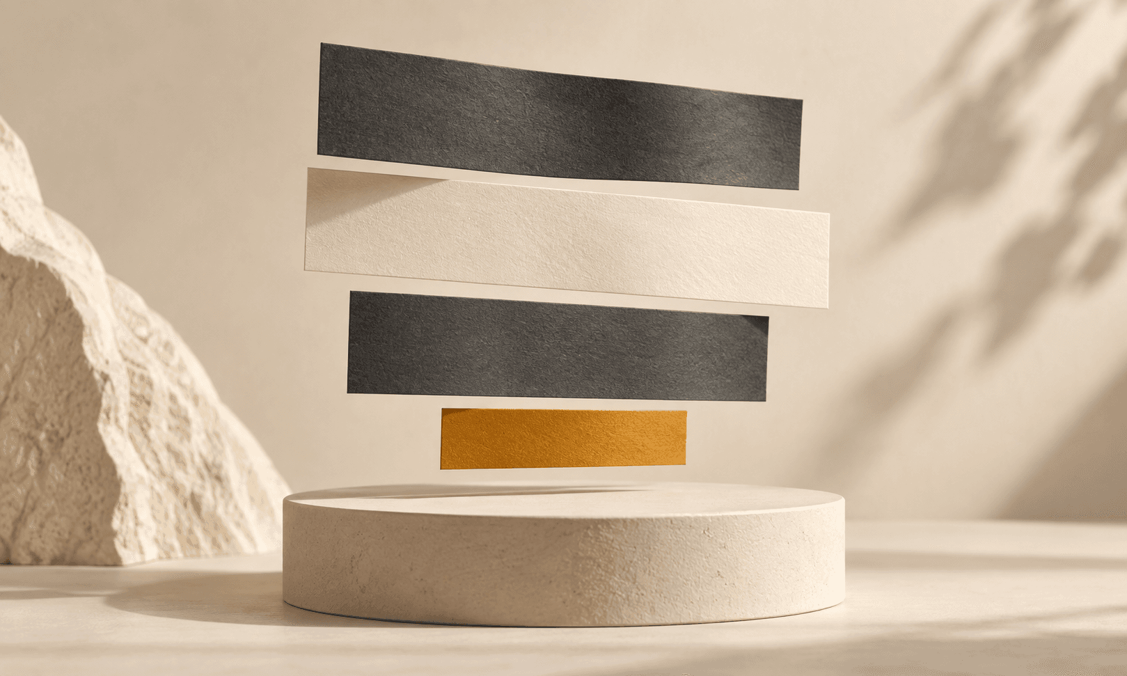 Separate charcoal, ivory, and amber strips float over a pale pedestal
