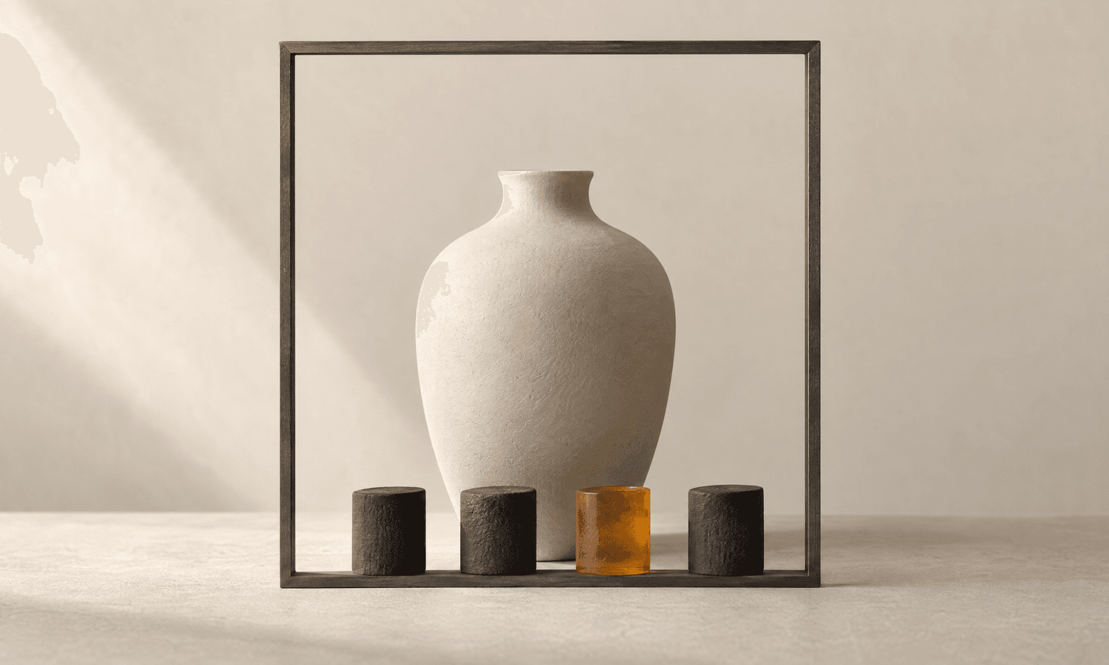 An ivory ceramic vase inside a thin graphite frame, with four small markers along the base and one of them amber
