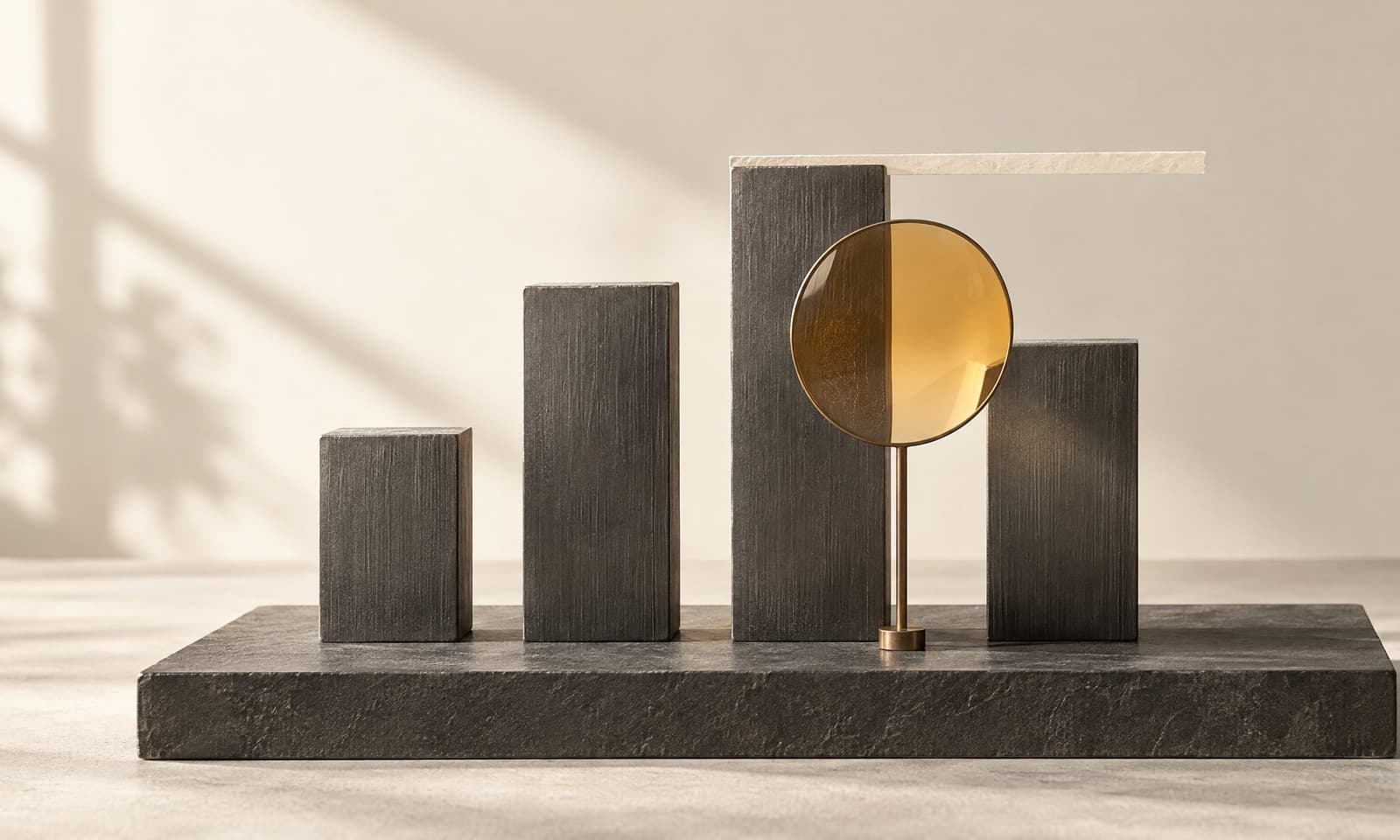 Four graphite bars of different heights on a charcoal base with an amber glass magnifying lens in front of the third bar
