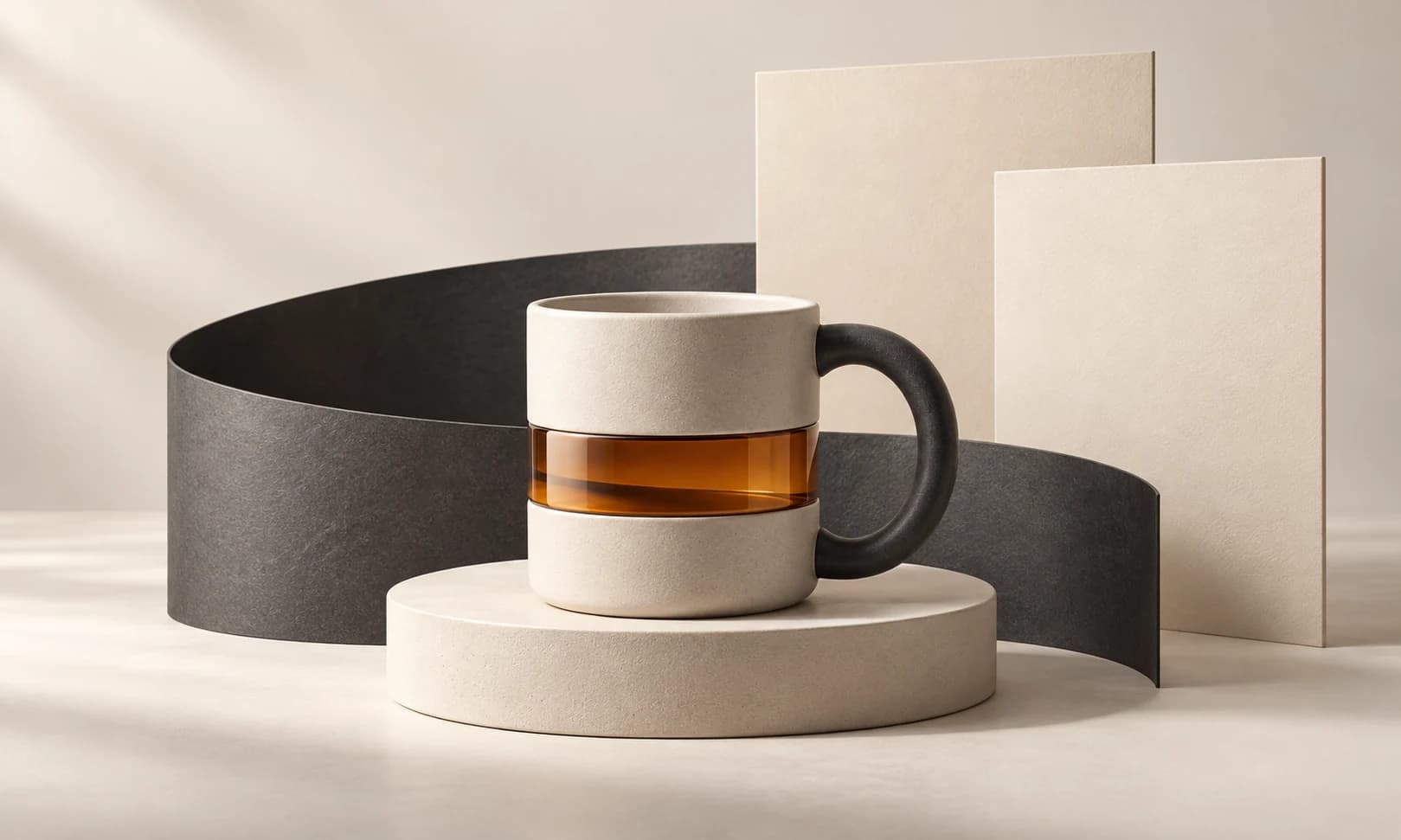 An ivory mug with a charcoal handle and amber band, framed by a sweeping graphite ribbon.