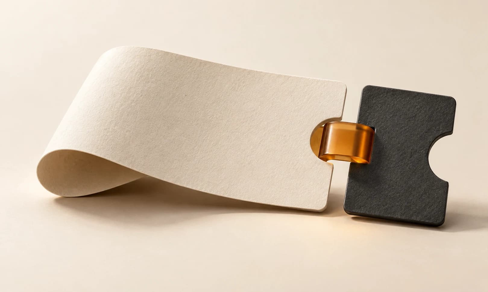A sculptural ivory ticket form with charcoal edges and a restrained amber accent.