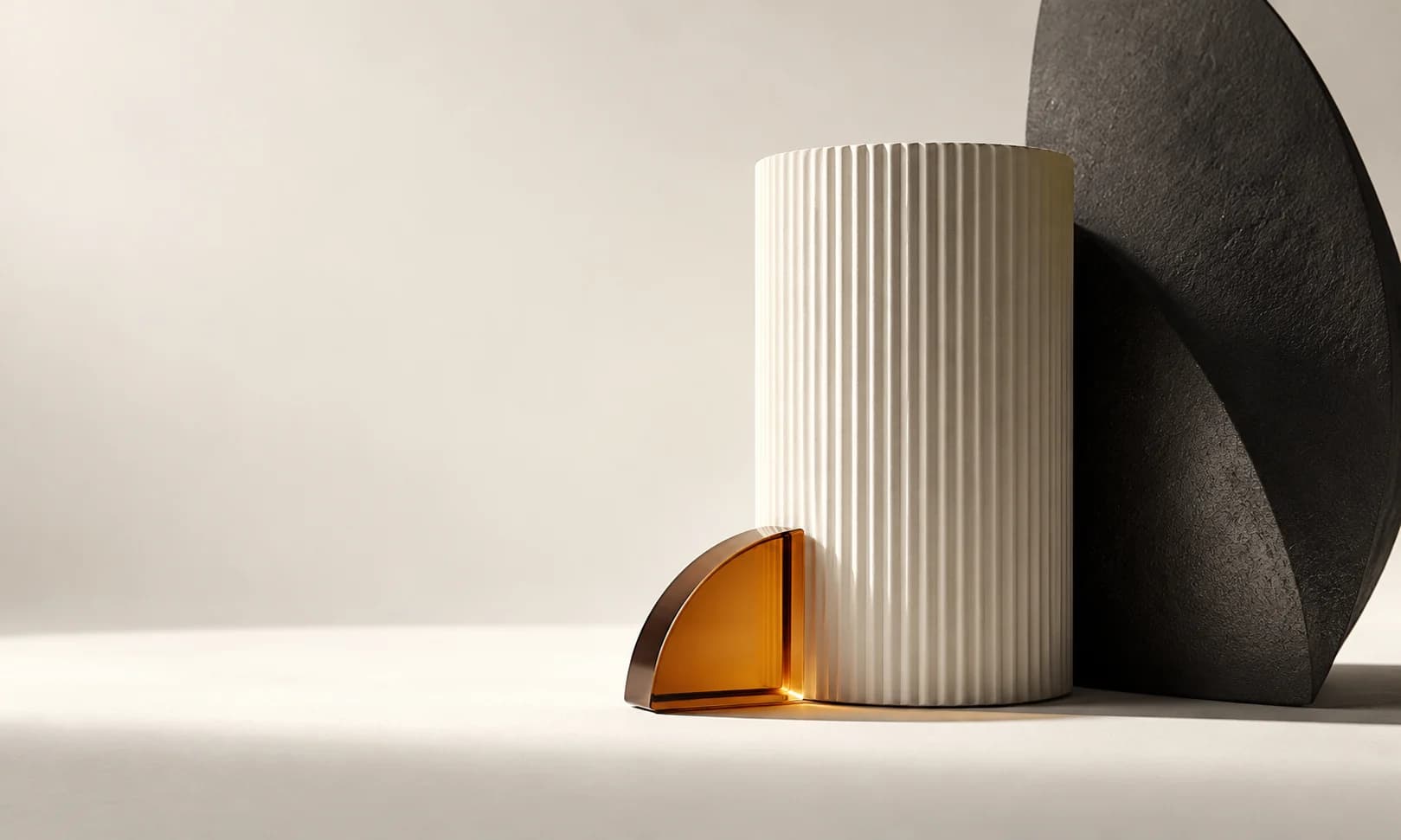 White ceramic forms separated by soft shadows on an ivory paper surface