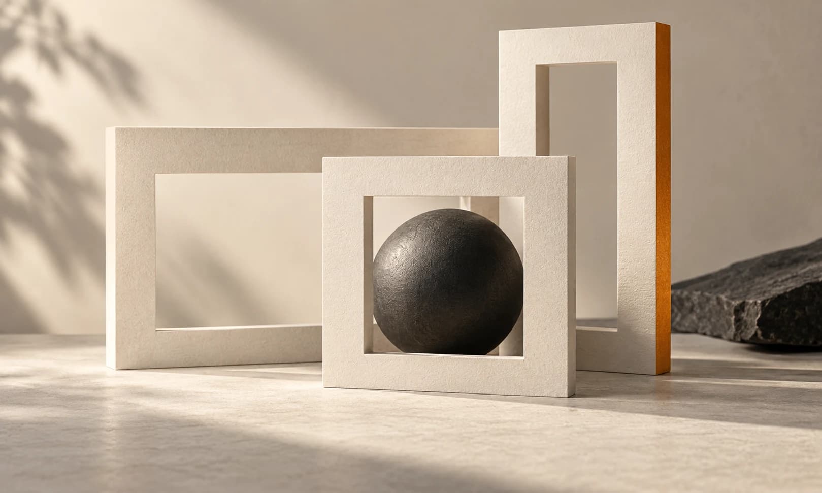 Separate ivory and charcoal panels balanced with an amber form