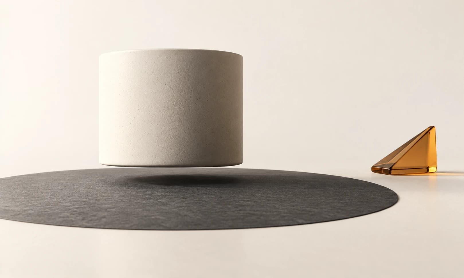 An ivory cylinder floating just above a charcoal oval with a soft contact shadow