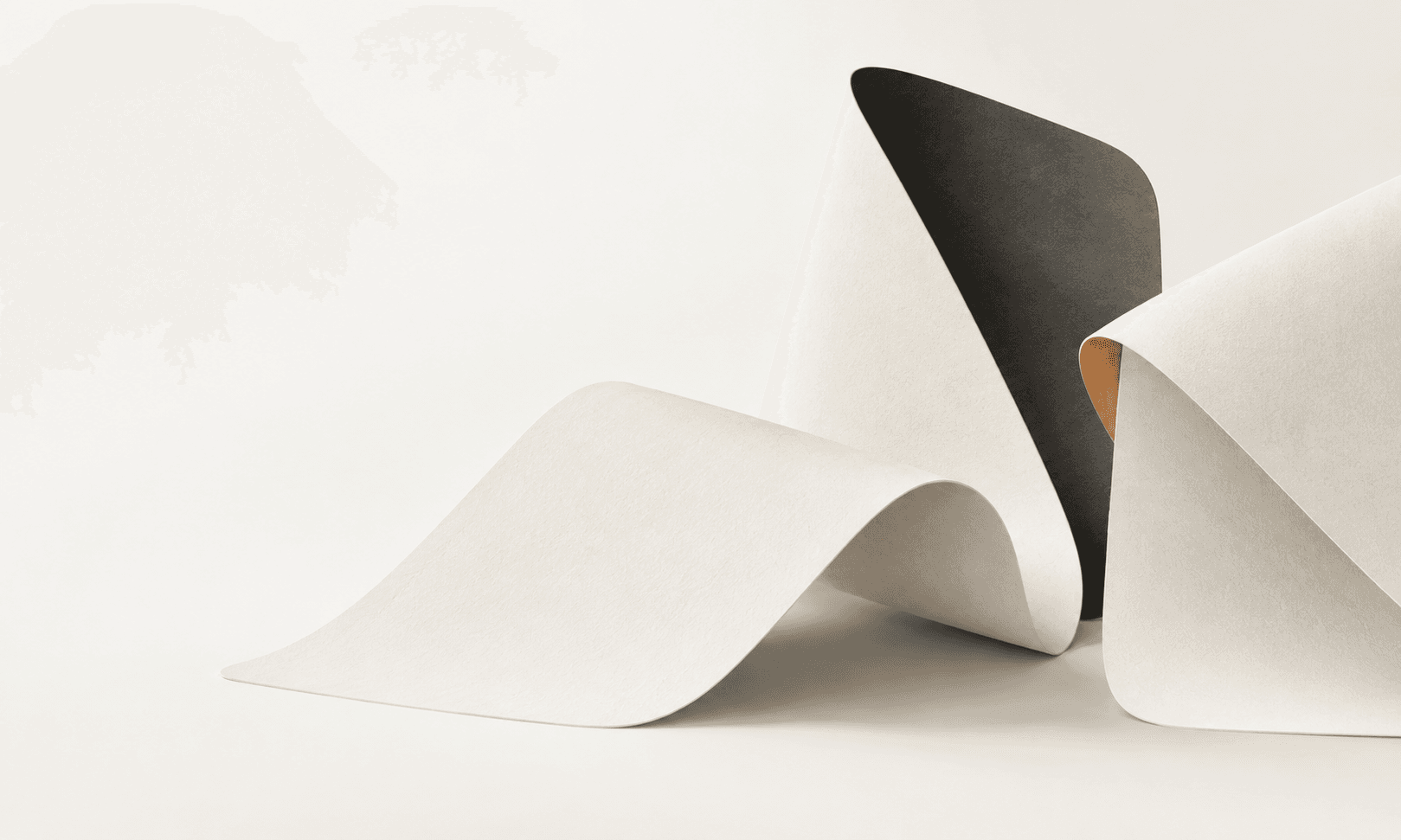 Sculptural ivory paper folds reveal charcoal backs and a small apricot inner edge