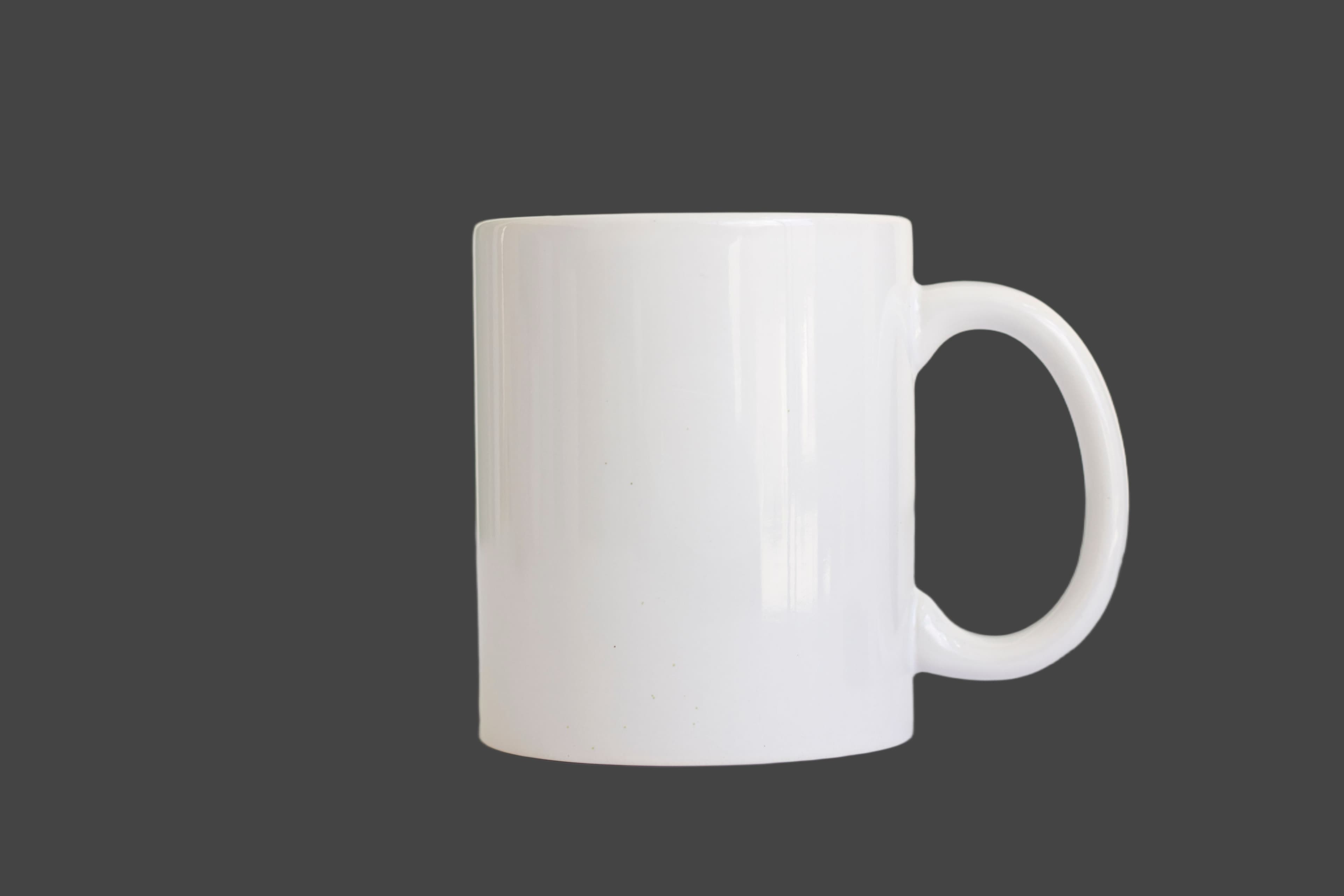 The same white mug cutout on charcoal, showing the handle opening and residual edge tint