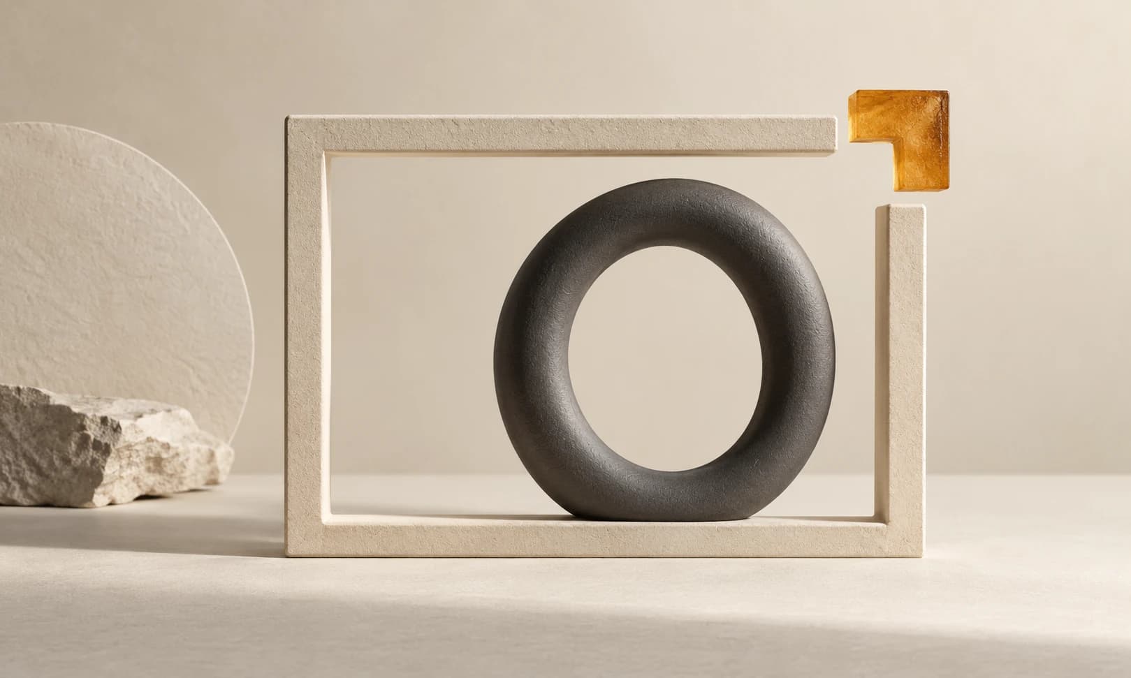A charcoal ceramic loop inside an ivory frame with an amber corner